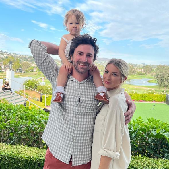 A photo of Beau Clark, Stassi Schroeder, and their daughter