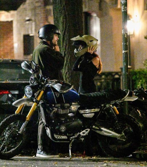 Emily Ratajkowski and Orazio Rispo putting on motorcycle helmets