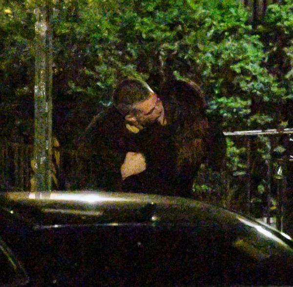 Emily Ratajkowski and Orazio Rispo kissing on a sidewalk