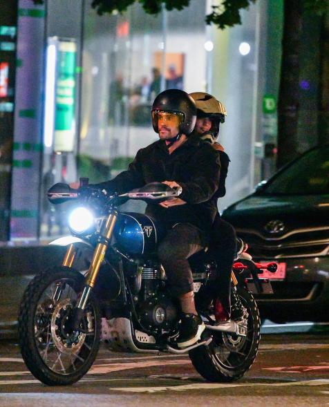 Emily Ratajkowski and Orazio Rispo riding a motorcycle