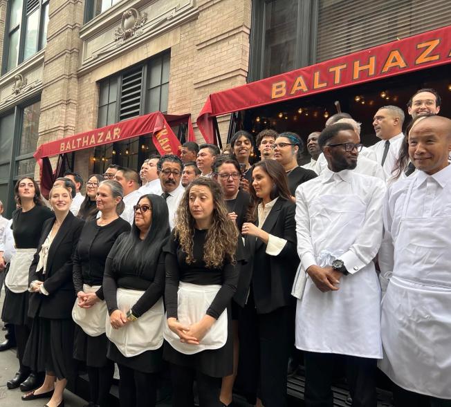 balthazar staff standing outside the restaurant