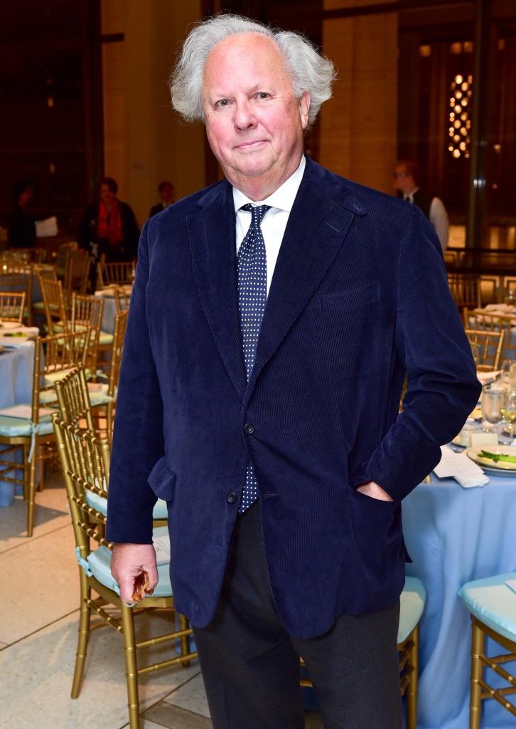 graydon carter standing in front of tables