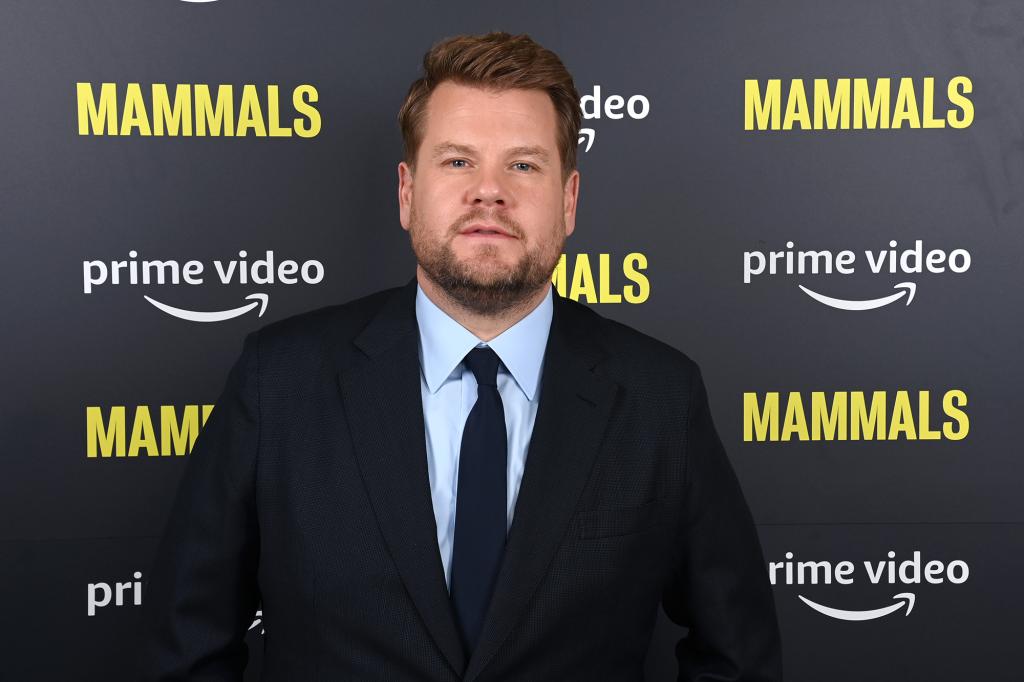 james corden standing on a red carpet