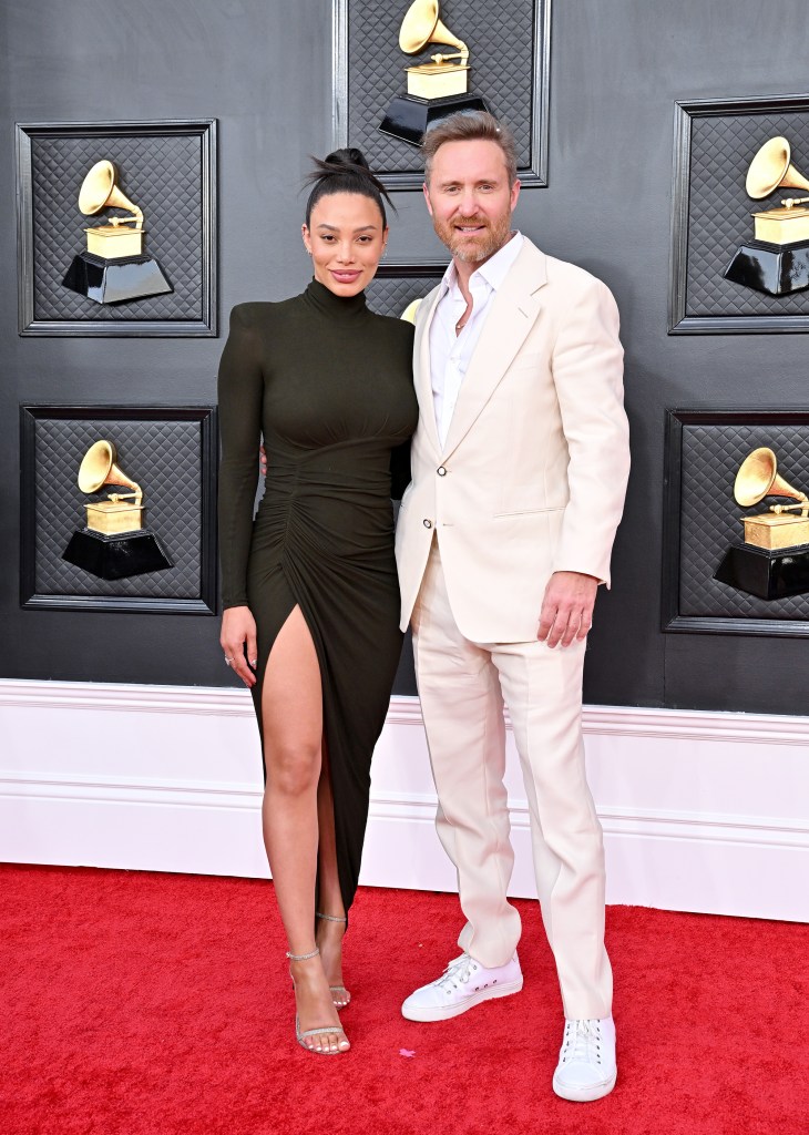 David Guetta and Jessica Ledon on a red carpet.