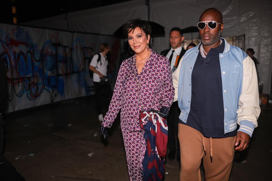 Kris Jenner and Corey Gamble walking together.