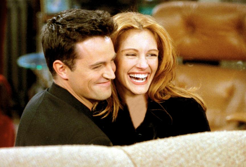 Matthew Perry and Julia Roberts on Season 2 of "Friends" hugging and laughing.