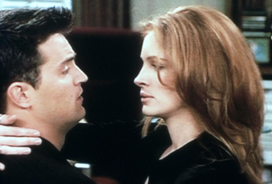 Matthew Perry and Julia Roberts on Season 2 of "Friends" hugging and laughing.