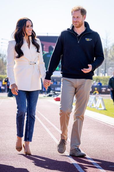 Meghan Markle and Prince Harry holding hands.