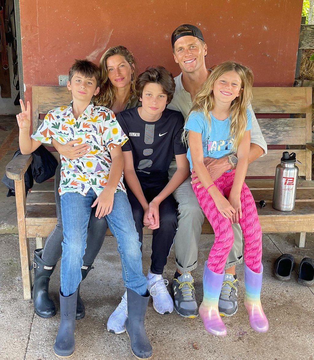 Gisele Bündchen, Tom Brady and their three kids sitting on a bench. 