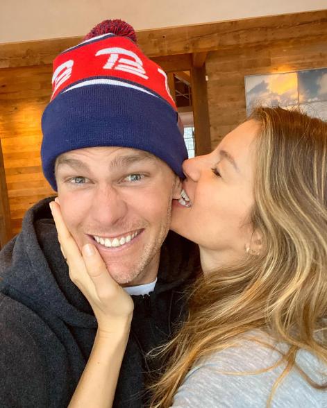 Gisele Bündchen biting Tom Brady's ear.