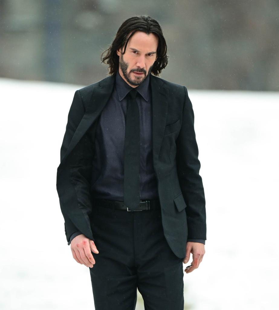 Keanu Reeves standing in the snow.