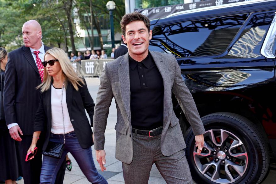 Zac Efron getting out of a car