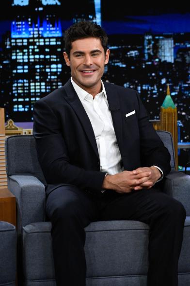 Zac Efron sitting on "The TOnight Show"