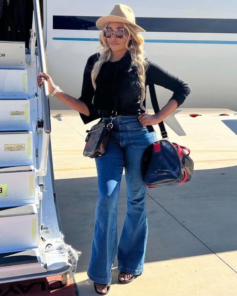 Cynthia Bailey posing in front of a private plane