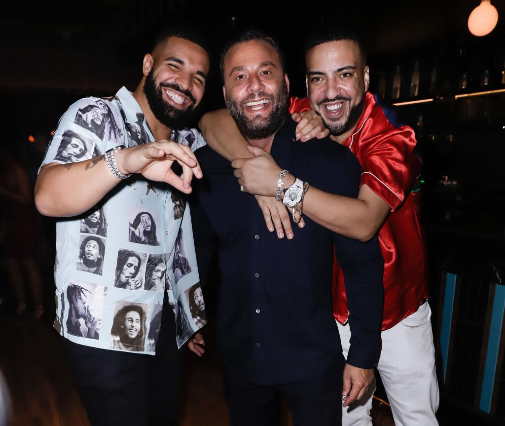 Drake, David Grutman and French Montana posing together at a party.