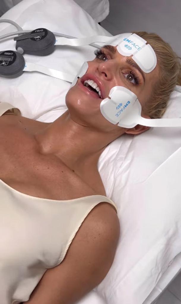 Jessica Simpson lying down during an Emface treatment.