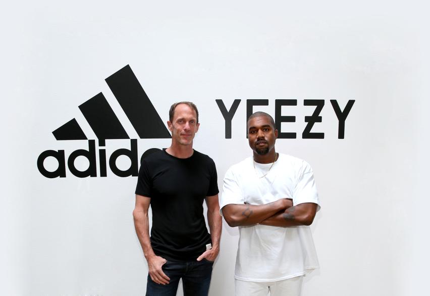 Kanye West and Eric Liedtke posing for a photo together.