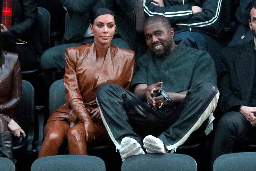 Kim Kardashian and Kanye West watching a basketball game