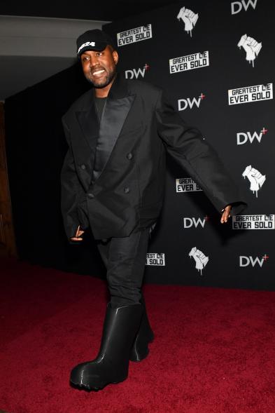 Kanye West walking on a red carpet.