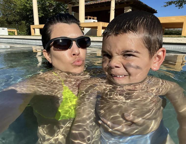 Kourtney Kardashian and Reign Disick in the pool