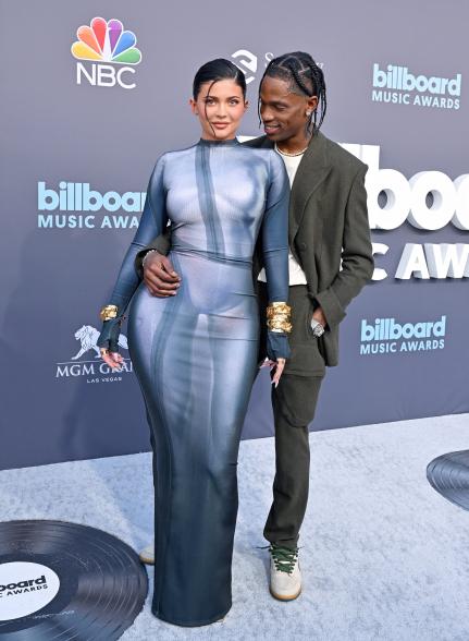 Kylie Jenner and Travis Scott posing together on a red carpet.