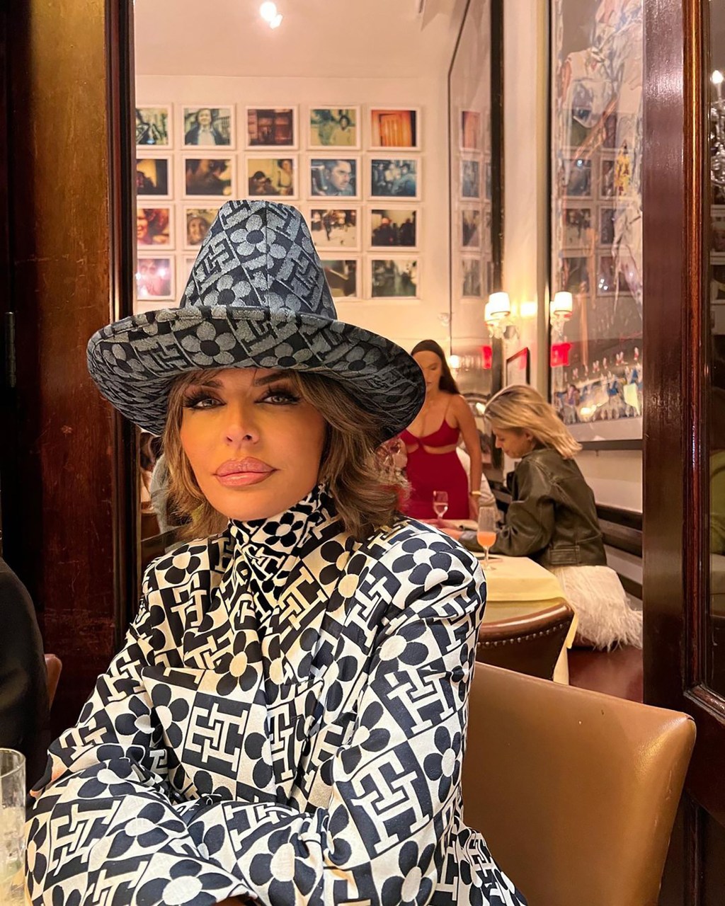 Lisa Rinna sitting at a restaurant table.