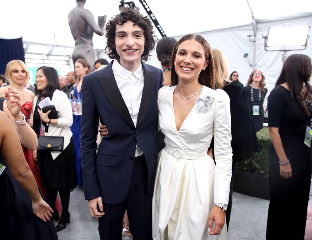 Finn Wolfhard and Millie Bobby Brown posing together at the 2020 SAG Awards.