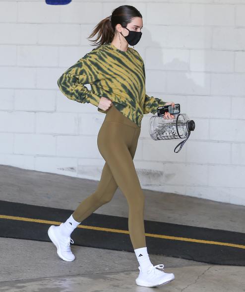 Kendall Jenner in a tie dye top and green leggings