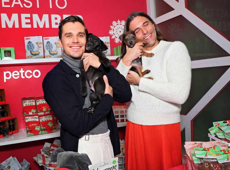 Antoni Porowski and Jonathan Van Ness holding puppies