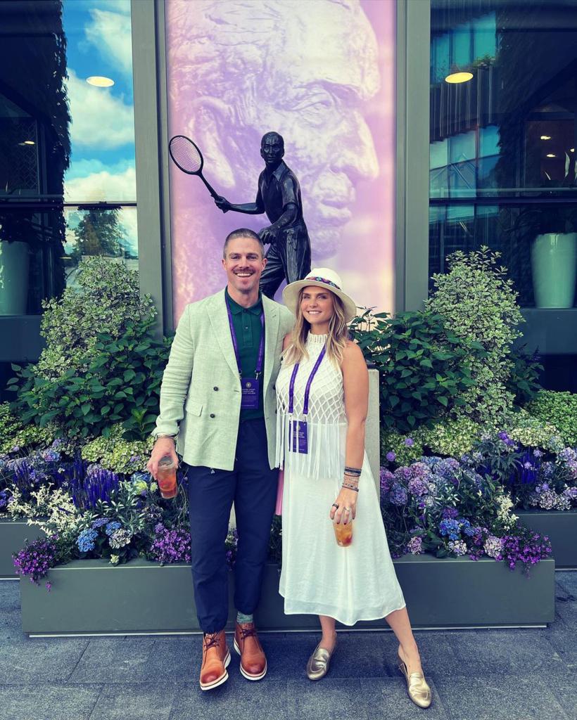 Stephen Amell and Cassandra Jean posing together outdoors.