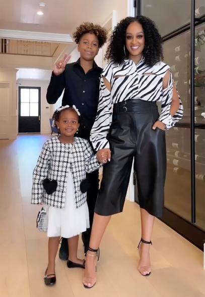 Tia Mowry and her kids in black and white outfits.