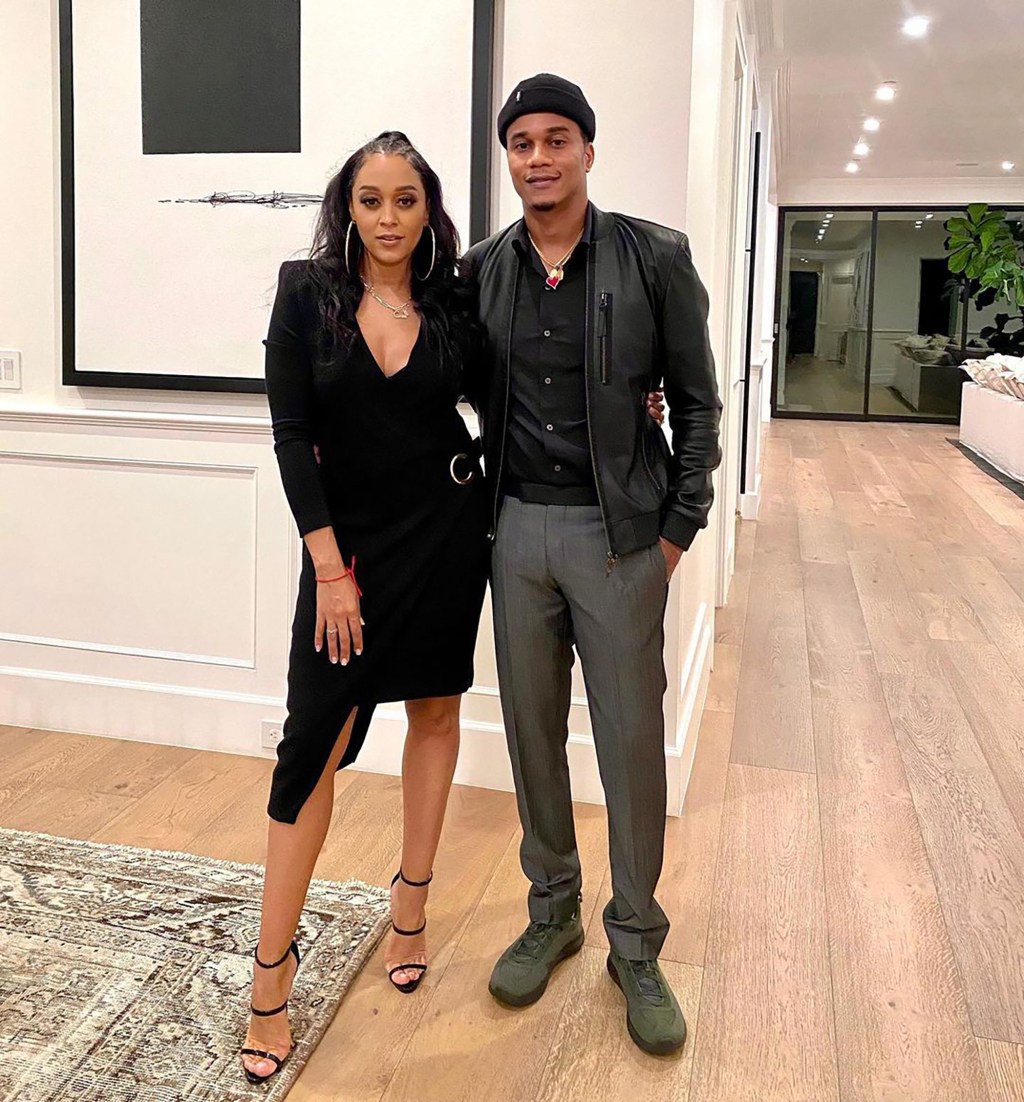 Tia Mowry and Cory Hardict in black outfits.