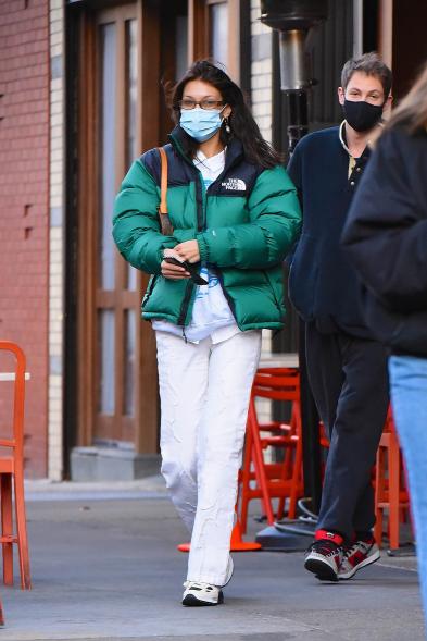 Bella Hadid in a green North Face puffer jacket