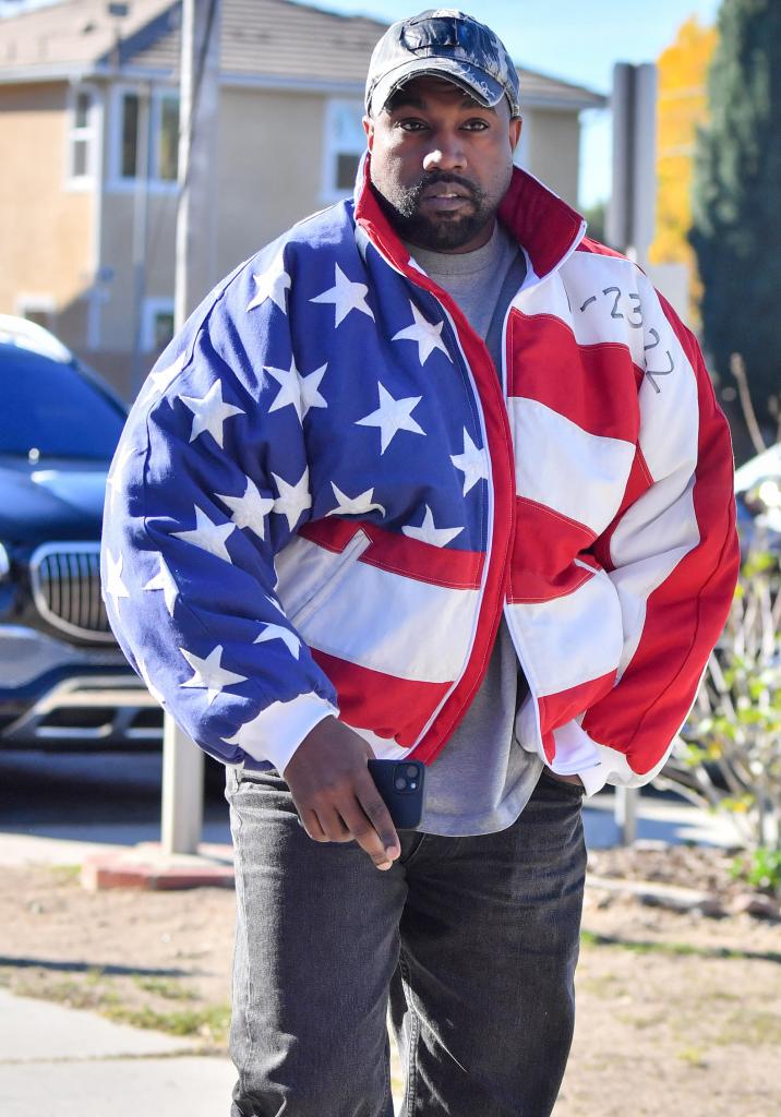 Kanye West wearing an American flag jacket.