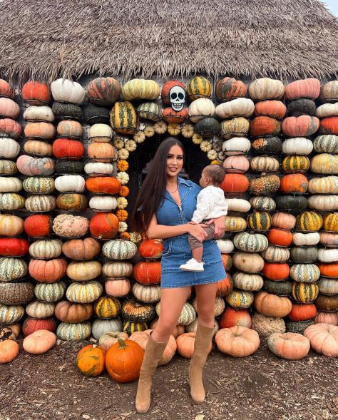 maralee nichols and her son theo in front of pumpkins