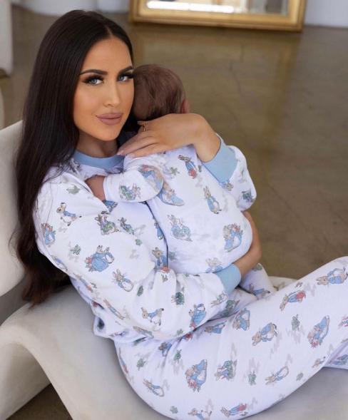 maralee nichols holding her son theo in matching pajamas