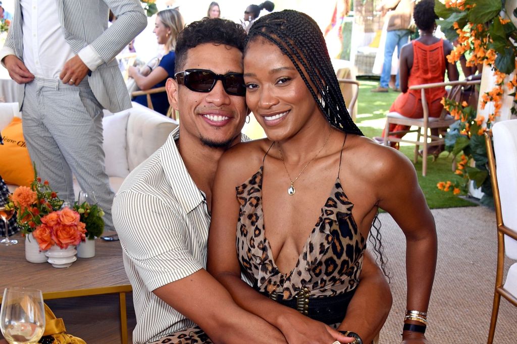 Keke Palmer sits on Darius Jackson's lap in animal-print dress