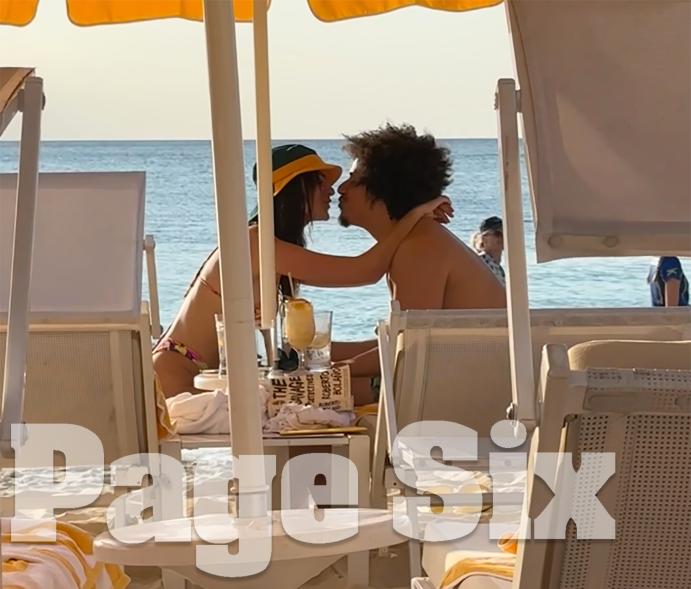 Emily Ratajkowski and Eric André kissing on the beach on Grand Cayman