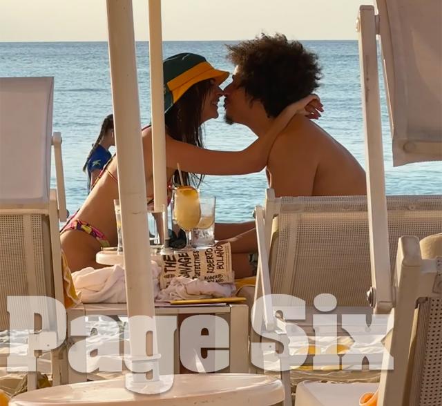 Emily Ratajkowski and Eric André kissing on the beach on Grand Cayman