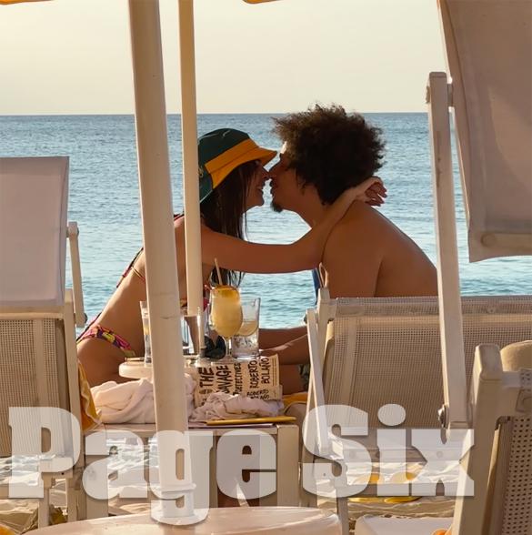 Emily Ratajkowski and Eric André kissing on the beach on Grand Cayman