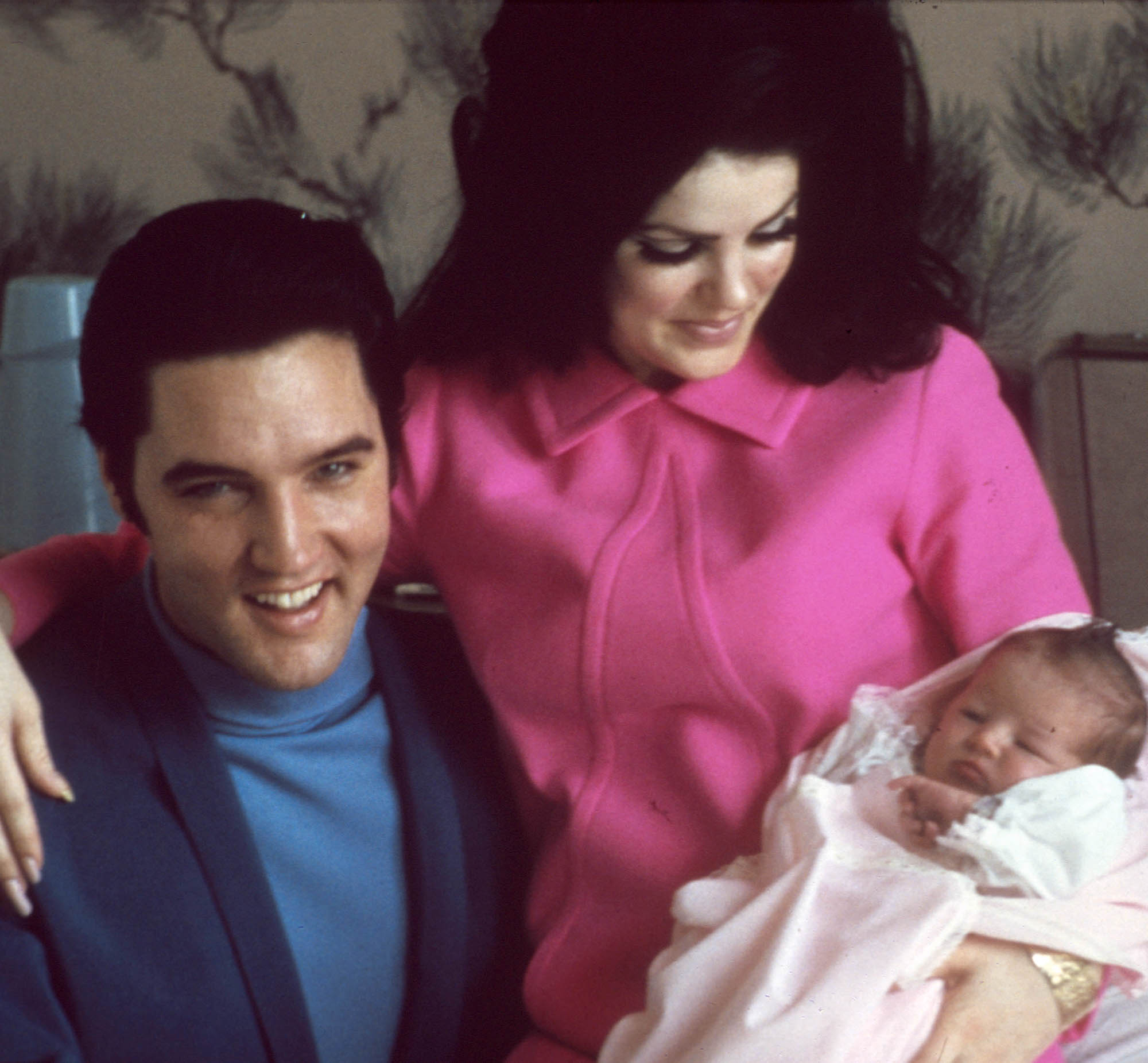 Priscilla Presley and Elvis Presley with Lisa Marie as a baby.