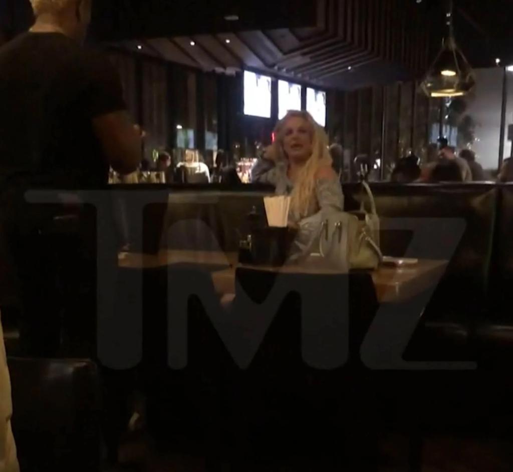 Britney Spears sitting in a restaurant.