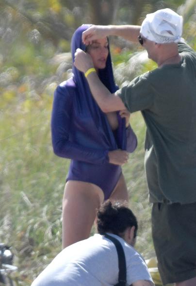 Gisele Bündchen modeling a purple swimsuit.