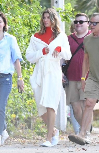 Gisele Bündchen at a photo shoot in a robe.