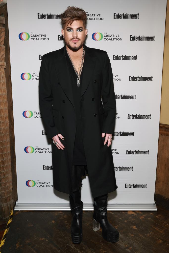 Adam Lambert posing on a red carpet.