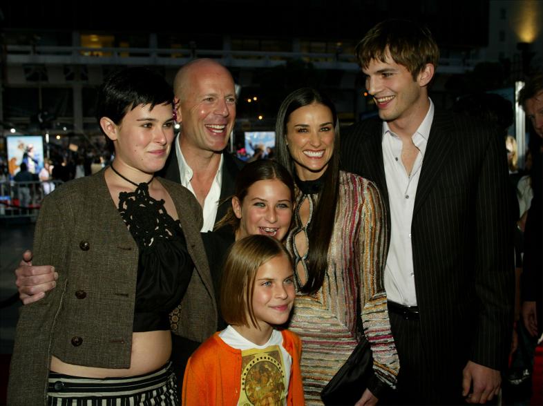 Ashton Kutcher smiles with Demi Moore, Bruce Willis and the former couple's three daughters