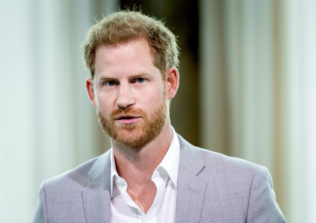 Prince Harry wearing a gray suit.