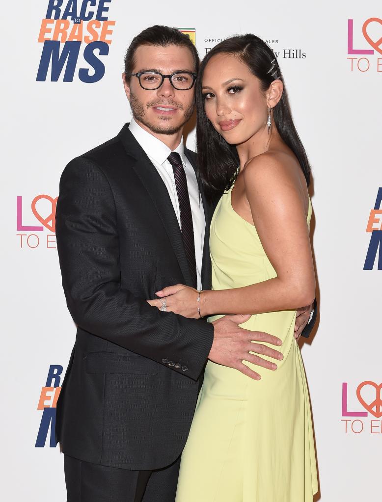 Matthew Lawrence and Cheryl Burke posing together on a red carpet.