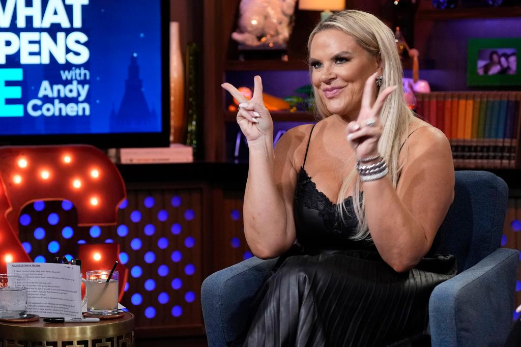 Heather Gay giving a peace sign while sitting on "WWHL"