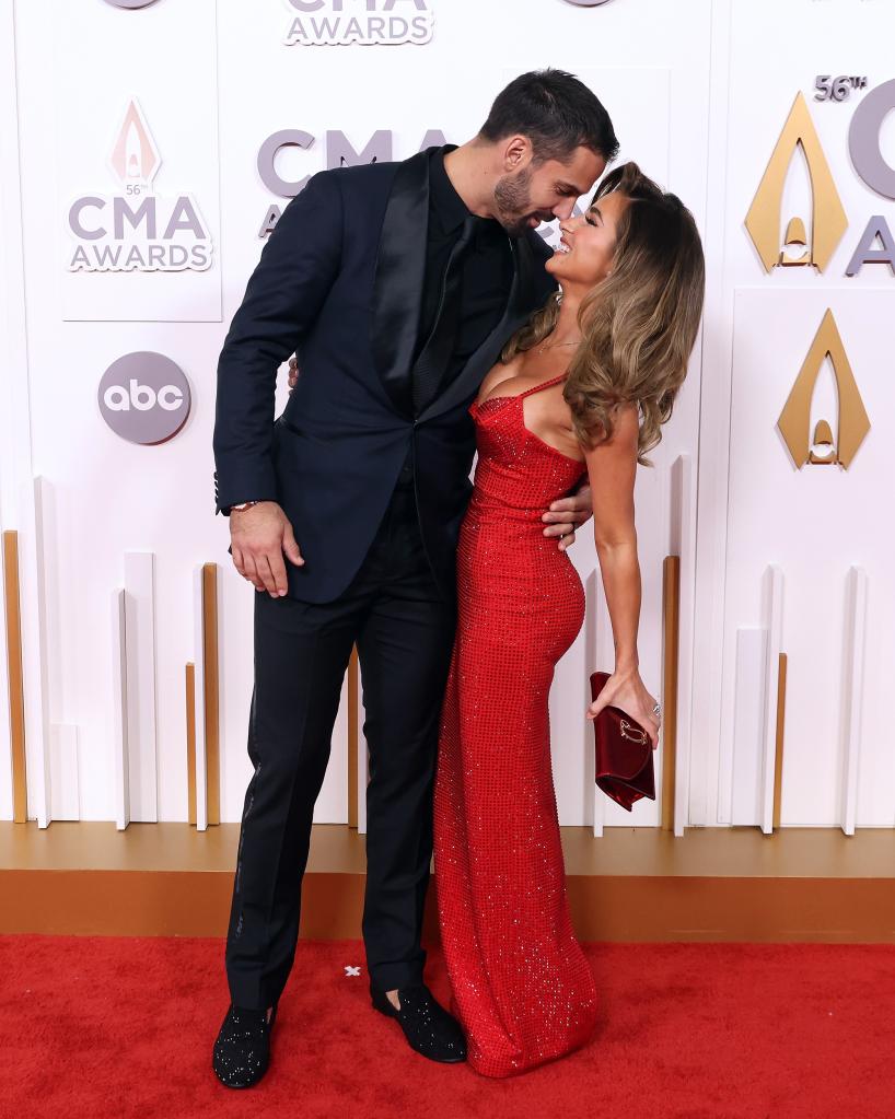 Jessie James Decker wears a red dress with suited Eric Decker